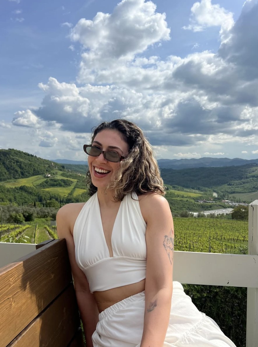 Gülbahar outdoors on a sunlit mountain hillside